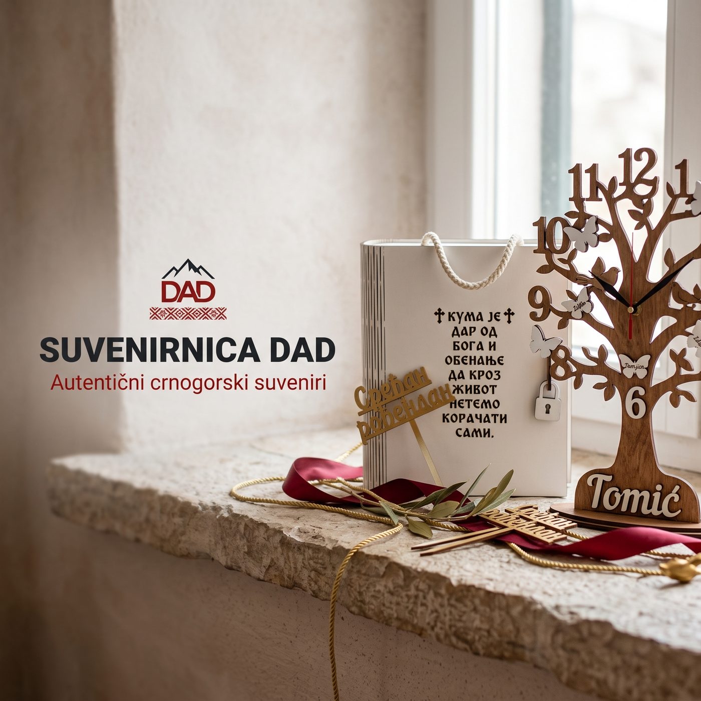 Family Tree clock, a godmother gift box and a medal on a window sill, with the Suvenirnica DAD sign